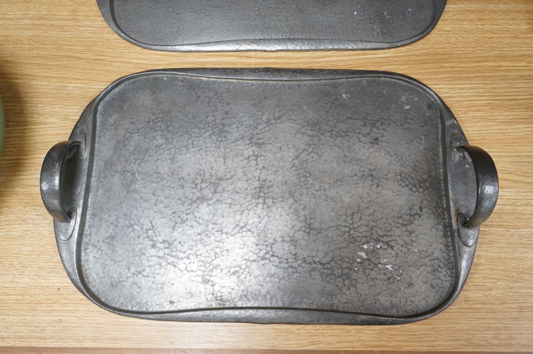 Archibald Knox for Liberty, two pewter Arts and Crafts Tudric trays, each numbered 043, 46cm wide